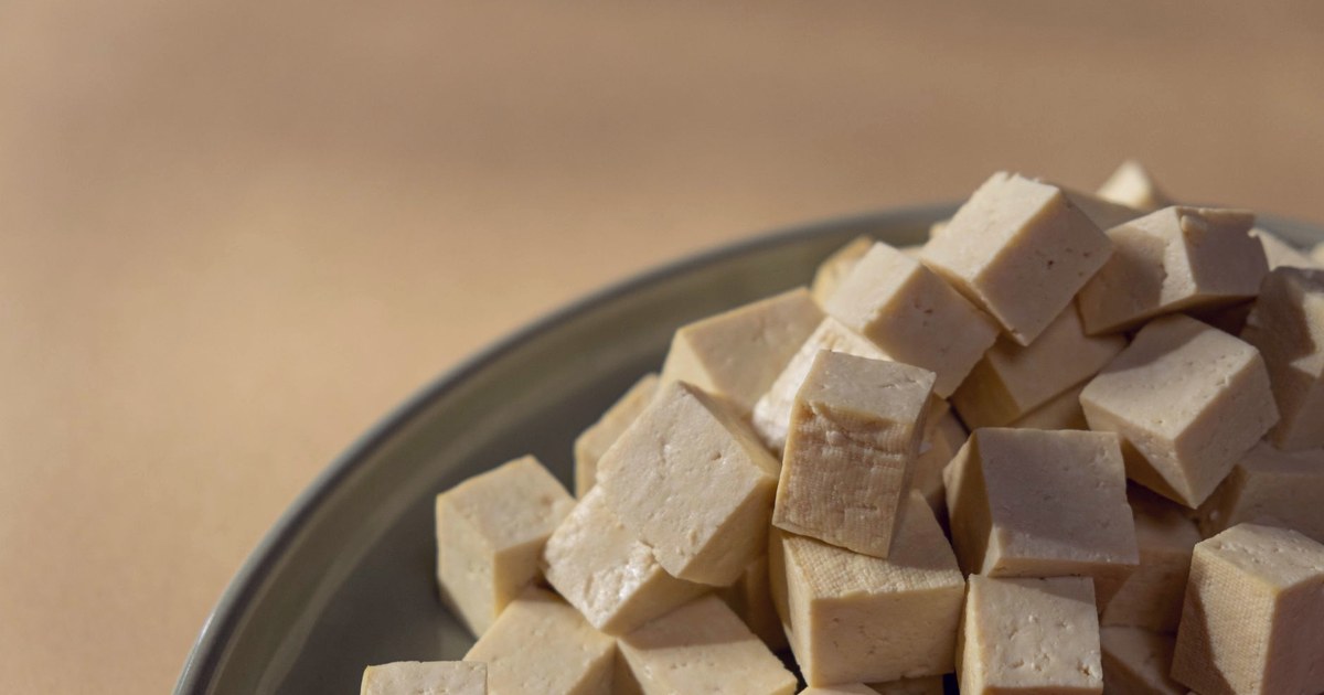Cubes of a pale, tofu-like block food stacked on a plate, visually similar to the non-dairy paneer analogues FSSAI's draft rule targets