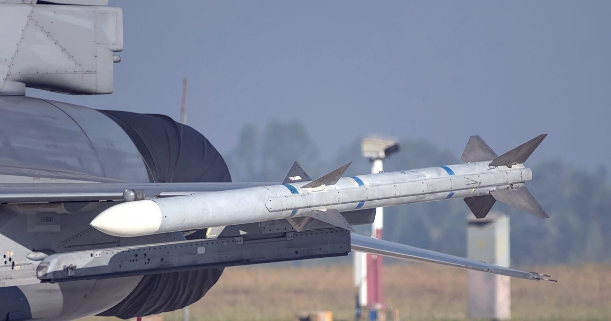 Close-up of a missile mounted on a fighter jet's wing on the tarmac at an air show in Bengaluru, India