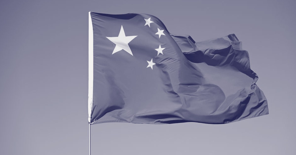 China's national flag flying against a clear sky