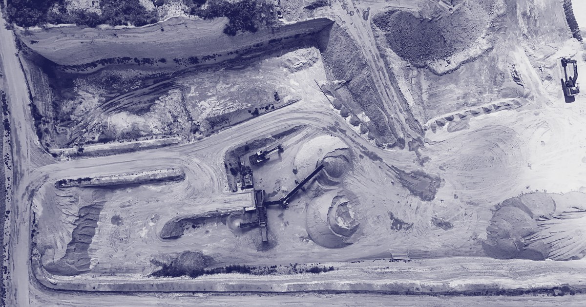 Aerial view of a quarry with excavation machinery extracting and processing materials