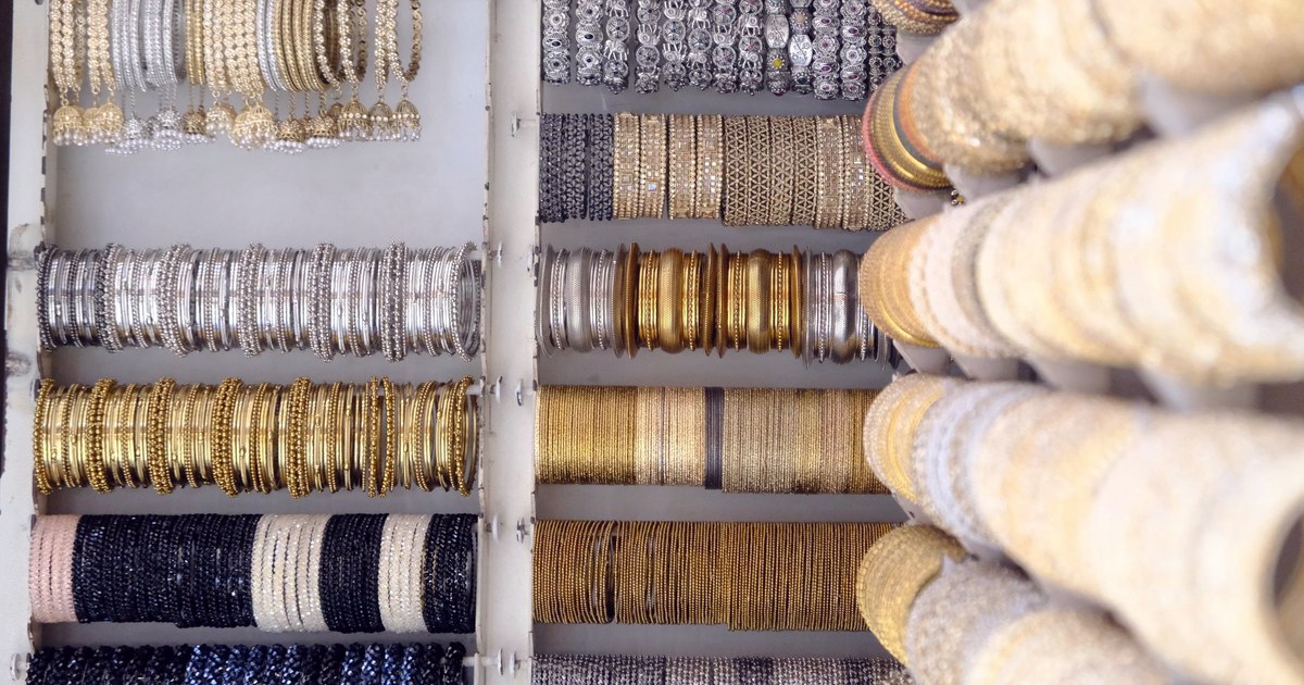 Rows of gold and silver bangles displayed on a jewellery shop rack in India