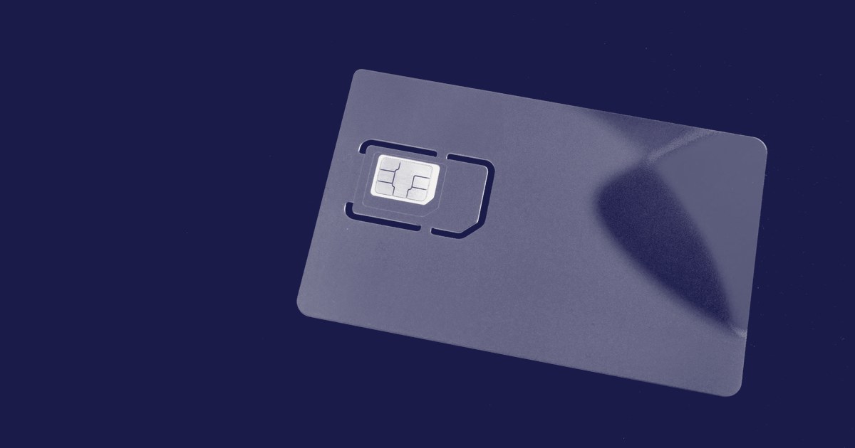 A SIM card with a visible chip lying on a dark navy background