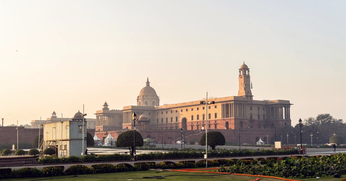 Rashtrapati Bhavan, the Indian presidential palace in New Delhi, at sunrise with manicured lawns in the foreground