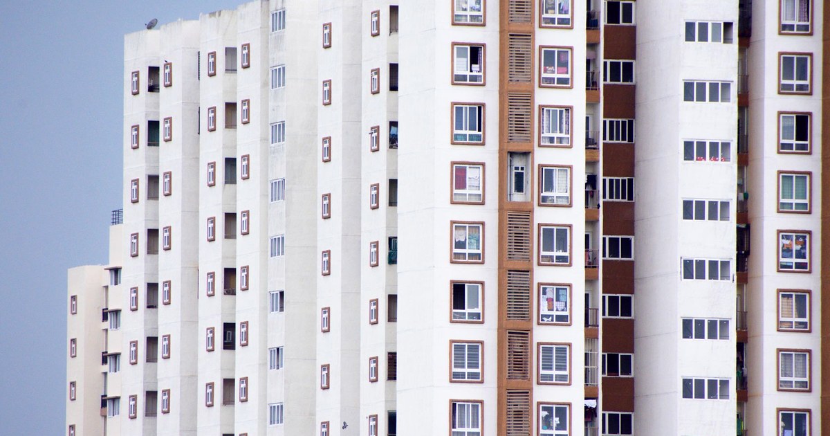 Dense high-rise residential apartment towers in Bengaluru, with rows of identical windows and balconies