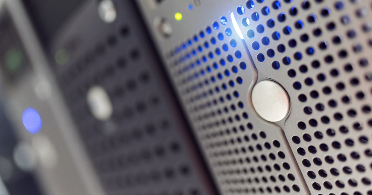 Close-up of an illuminated server rack with blue status lights, the kind of automated trading infrastructure SEBI's new AI rules are aimed at