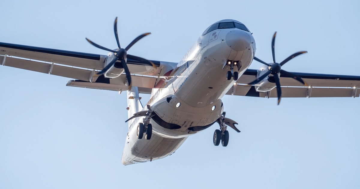 An ATR 72 turboprop aircraft, the aircraft type widely flown on India's regional UDAN routes, banking on approach against a clear sky